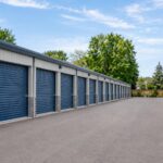 Rows of outdoor self-storage units surrounding a paved drive